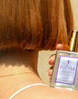 Rahua by Amazon Beauty Color Full Glossing Oil Mist - Model shown holding product