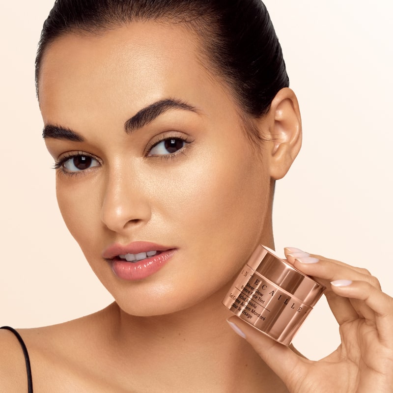 Chantecaille Sheer Glow Bronze Face Tint - Model shown holding product next to face