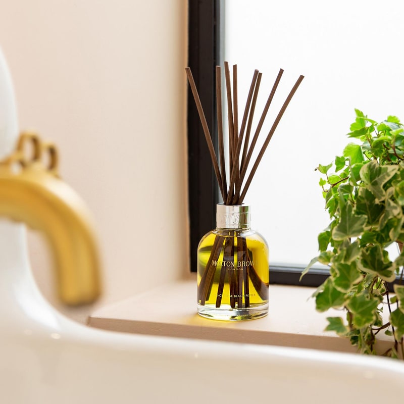 Molton Brown Re-Charge Black Pepper Aroma Reeds Diffuser - Product displayed on window sill