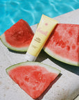 Bask Sunscreen SPF 50 Lotion Sunscreen - Beauty shot, product displayed next to pool and watermelon