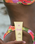 Bask Sunscreen SPF 50 Lotion Sunscreen - Model shown holding product in front of body