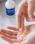Ursa Major Brighten Up Vitamin C Serum - Product shown in models hand