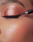 Roen Beauty Eyeline Define Eyeliner Pencil – Matte Black - Model shown applying product to eye