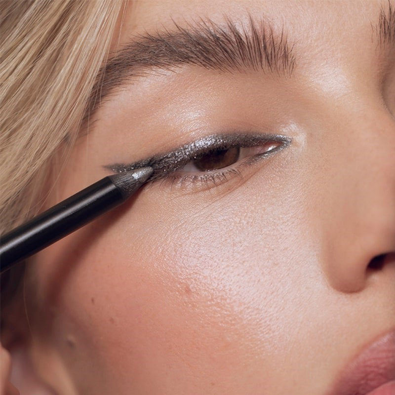 Roen Beauty Eyeline Define Eyeliner Pencil – Shimmering Gunmetal - Closeup of model applying product to eye