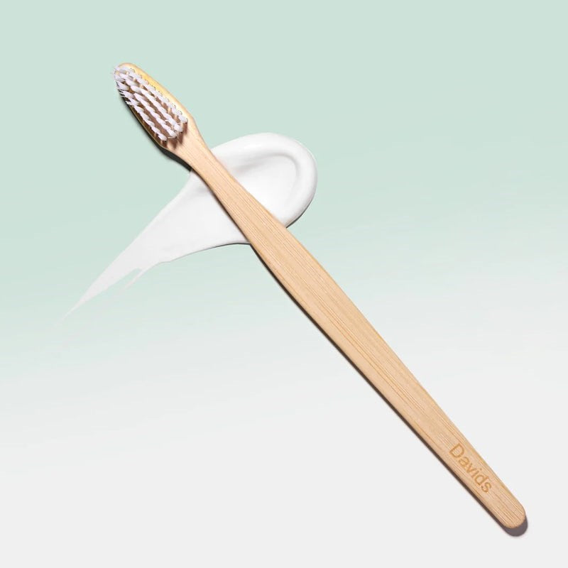 Davids Premium Bamboo Toothbrush - Product shown on top of toothpaste smear