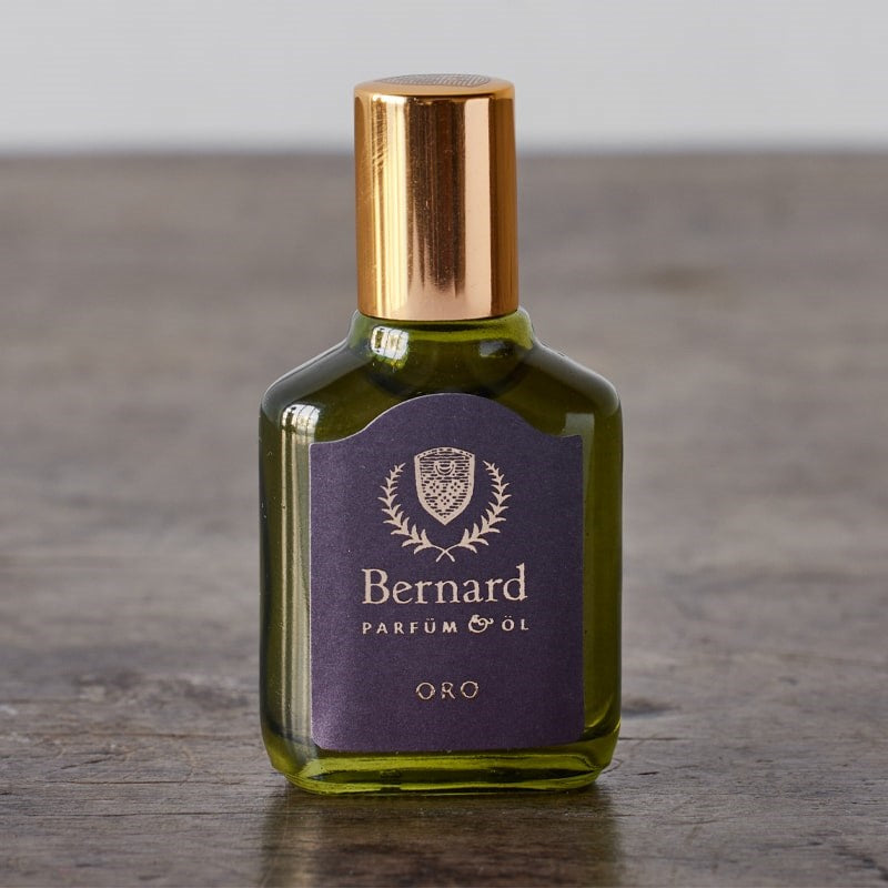 Bernard Parfum Oro Roll On Parfum Ol Bijou - Product displayed on wood table