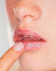 Yolaine The Lip Scrub - Closeup of model applying product to lips