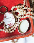 Yolaine The Lip Scrub - Beauty shot - product shown on velvet tray with jewelry