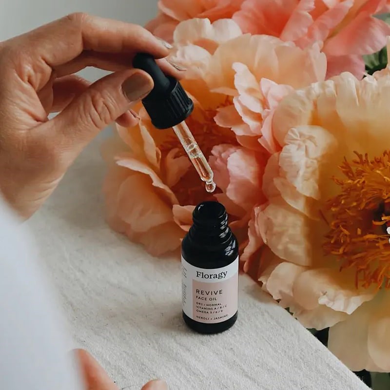Floragy Revive – Face Oil - Model shown with product dropper in hand