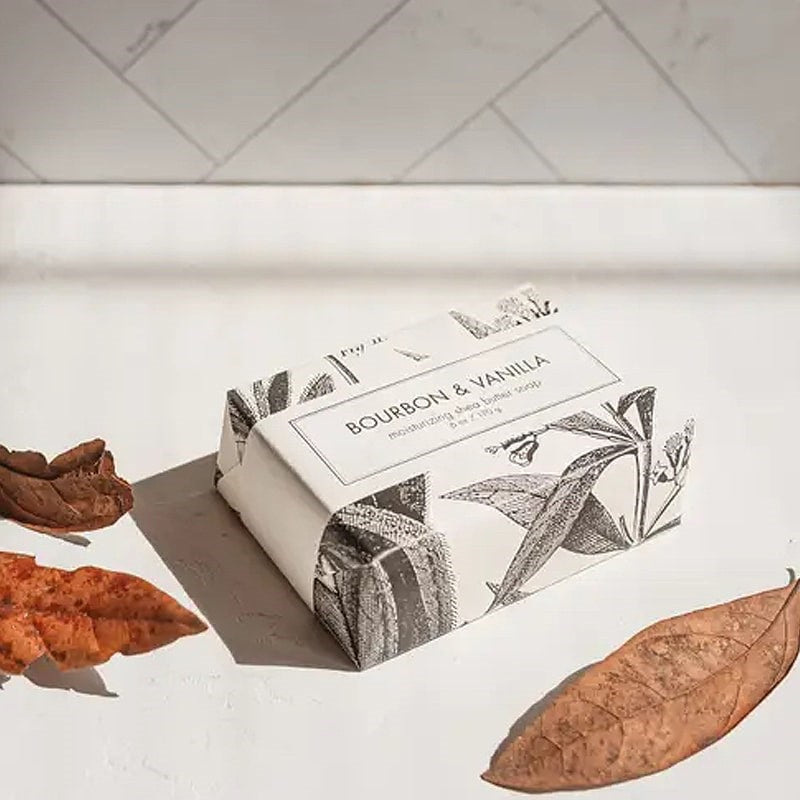 Formulary 55 Bourbon &amp; Vanilla Bath Bar - packaged bar of soap with dried leaves in the foreground