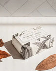 Formulary 55 Bourbon & Vanilla Bath Bar - packaged bar of soap with dried leaves in the foreground