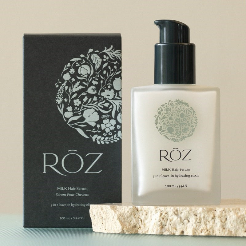 Roz Milk Hair Serum - Lifestyle shot of packaging and bottle on a slab of stone