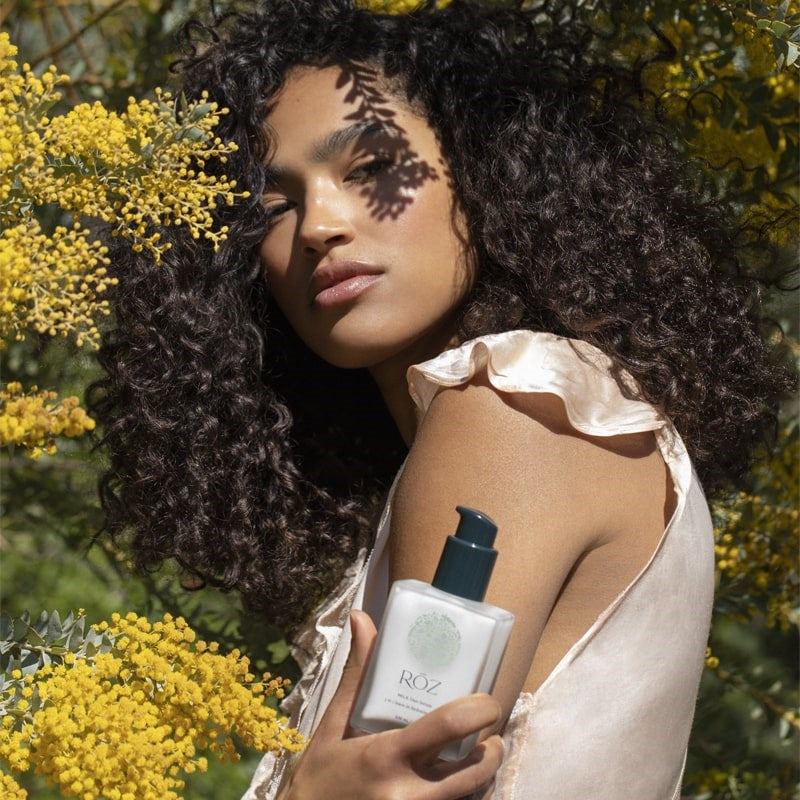 Roz Milk Hair Serum - lifestyle model shot holding product