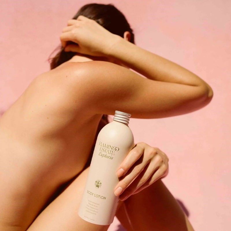 Flamingo Estate Organics Euphoria Body Lotion - Model shown holding product in front of body