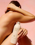 Flamingo Estate Organics Euphoria Body Lotion - Model shown holding product in front of body