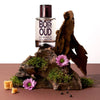 Solinotes Oud Wood Eau de Parfum - Beauty shot product shown with bark and flowers