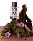 Solinotes Oud Wood Eau de Parfum - Beauty shot product shown with bark and flowers