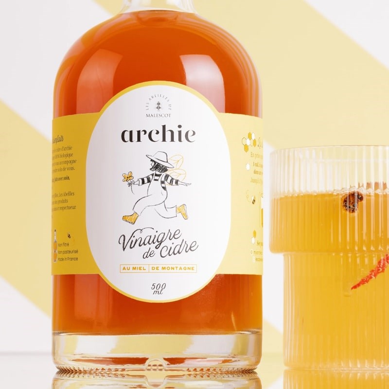 Les Abeilles de Malescot Cider Vinegar with Honey- Product shown next to full glass