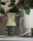 Eucalan Eucalyptus Delicate Wash - Beauty shot, product shown next to plant