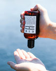 Eir NYC Sunset Oil - Model shown dispensing product into hand