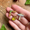 Georgiou Draws Woodland Seeds Mini Enamel Pin Badge Set- Product shown in models hand
