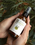 8 Days Botanicals Evergreen Botanical Ritual Room Spray - Product shown in models hands