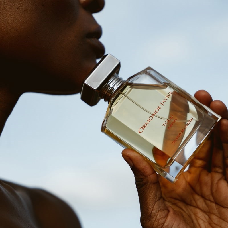 Ormonde Jayne Tolu Eau de Parfum (88 ml) - Model shown holding product next to face