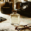Ormonde Jayne Montabaco Intensivo Eau de Parfum - lifestyle shot of perfume bottle, glasses, phone on a map