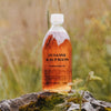 Susanne Kaufmann Hayflower Bath Oil - Beauty shot, product shown on rock