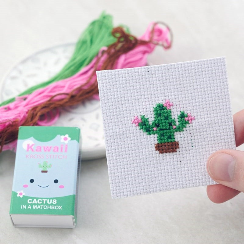 Marvling Bros Ltd  Kawaii Cactus Cross Stitch Kit In A Matchbox showing finished piece in model's hand