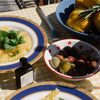 Versatile Paris Rital Date Extrait de Parfum - lifestyle photo of perfume bottle on table with plates of food