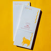 Bromstad Printing Co. Squiggle Tail Cat Risograph Notepad - two notepads on yellow background