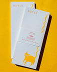 Bromstad Printing Co. Squiggle Tail Cat Risograph Notepad - two notepads on yellow background