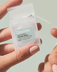 Davids Expanding Dental Floss - Refillable Dispenser + Refill - Mint - Product shown in models hand