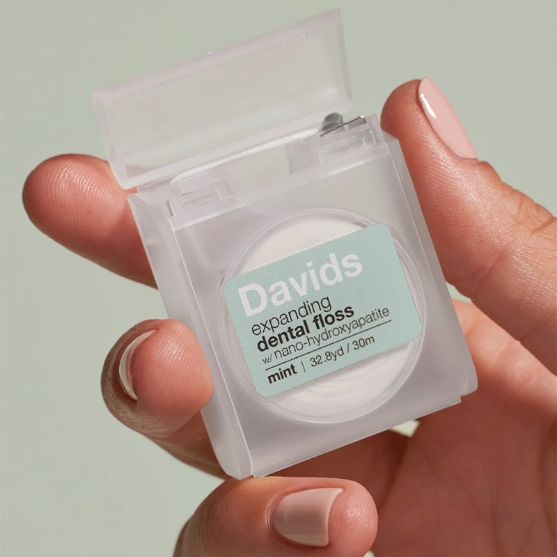 Davids Expanding Dental Floss - Refillable Dispenser - Mint - Product shown in models hand