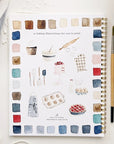 Emily Lex Studio Baking Watercolor Workbook - Product shown next to paint brush