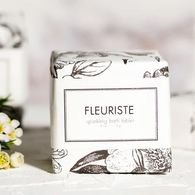 Formulary 55 Fleuriste Sparkling Bath Tablet- Product displayed next to flowers