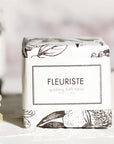 Formulary 55 Fleuriste Sparkling Bath Tablet- Product displayed next to flowers