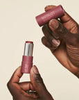 Pink House Organics Lip Tint - Merlot - model holding lip balm and cap