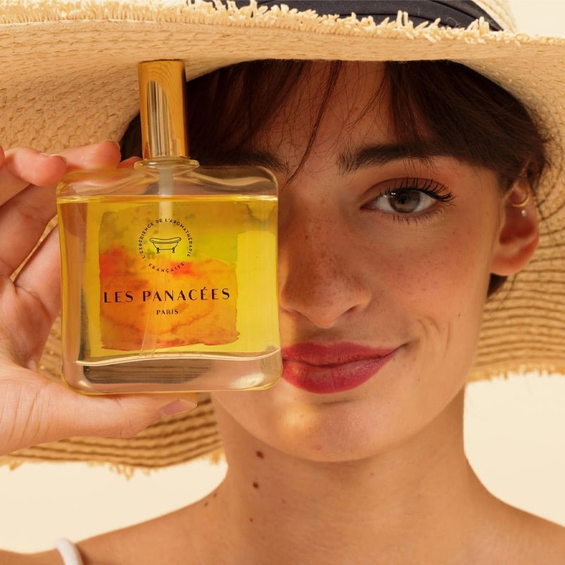 LES PANACEES Nourishing Dry Body and Hair Oil - Summer Essence - Model shown holding product in front of face