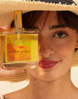 LES PANACEES Nourishing Dry Body and Hair Oil - Summer Essence - Model shown holding product in front of face