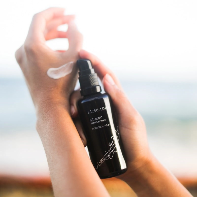 Kahina Giving Beauty Facial Lotion - Model shown dispensing product onto hand