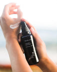 Kahina Giving Beauty Facial Lotion - Model shown dispensing product onto hand