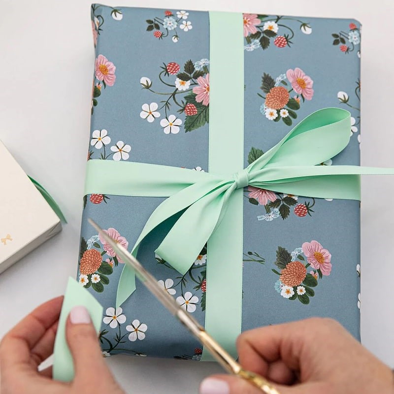 Bespoke Letterpress Mint Luxury Satin Ribbon - Model shown cutting ribbon on gift