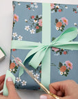 Bespoke Letterpress Mint Luxury Satin Ribbon - Model shown cutting ribbon on gift