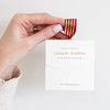 Bespoke Letterpress Red Gold Foil Striped Ribbon - Model shown holding ribbon box