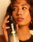 Oribe Gold Lust Dry Heat Protection Spray- Model shown with product in hand