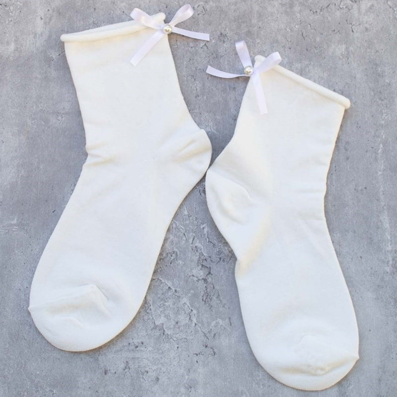 Tiepology Romantic Ribbon Pearl Socks - Ivory - Product shown on concrete background