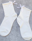 Tiepology Romantic Ribbon Pearl Socks - Ivory - Product shown on concrete background