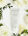 Leonor Greyl Shampooing Energisant - Fortifying and Volumizing Shampoo - Beauty shot, product shown with flowers